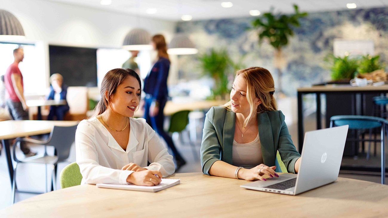 two people discussing behind desk